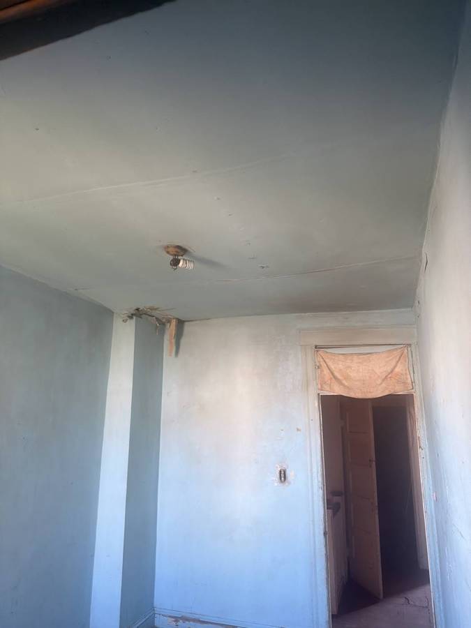 Hallway with plaster walls and ceiling before tear-out